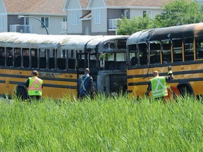 The aftermath is seen following a collision between two school buses on Autoroute 640 near Saint-Eustache, Que. on Tuesday, July 23, 2019.
