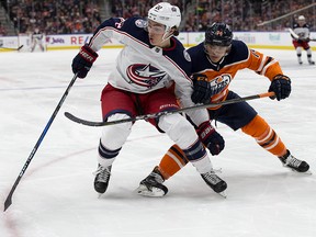Columbus Blue Jackets forward Sonny Milano tries to get past Edmonton Oilers defender Ethan Bear at Rogers Place in Edmonton Tuesday March 27, 2018. (David Bloom/Postmedia)