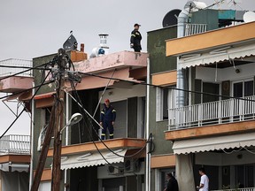 Firemen examine damage in an apartment following heavy storms at the beach of the village of Nea Plagia, Greece, July 11, 2019. (REUTERS/Alkis Konstantinidis)