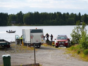 An emergency services boat carrying wreckage parts arrives at a harbour near the site, where a small sports aircraft with nine people on board has crashed at Ume river outside Umea, Sweden, July 14, 2019.