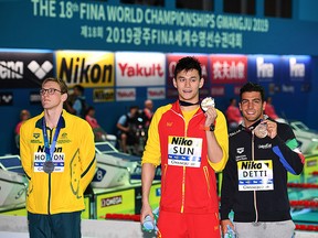 Silver medallist Mack Horton (left), gold medallist Sun Yang (middle) and bronze medallist Gabriele Detti pose after the final of the men's 400m freestyle during the World Championships at Nambu University Municipal Aquatics Center in Gwangju, South Korea, on July 21, 2019. (OLI SCARFF/AFP/Getty Images)