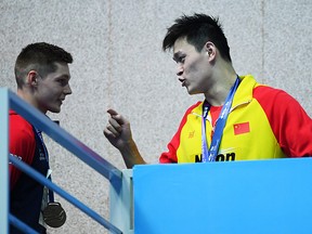 Sun Yang of China speaks with Duncan Scott of Great Britain during the World Championships at Nambu International Aquatics Centre on July 23, 2019 in Gwangju, South Korea. (Quinn Rooney/Getty Images)