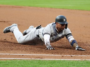 Gleyber Torres of the New York Yankees dives back to first after driving in a run in the second inning against the New York Mets during their game at Citi Field on July 2, 2019 in New York City.