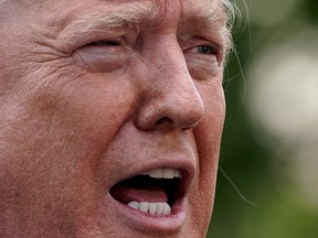 U.S. President Donald Trump talks with reporters as he departs the White House July 19, 2019 in Washington, D.C.