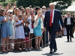 U.S. President Donald Trump walks towards members of the media prior to his departure from the White House July 5, 2019 in Washington, D.C.