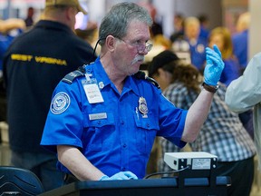 A TSA agent instructs travelers going through security lines at Pittsburgh International Airport on November 24, 2010. (Jeff Swensen/Getty Images)