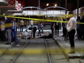 Authorities work at a scene after a man reported to be wearing an explosive belt died in the Intilaka area in Tunis, Tunisia July 2, 2019.