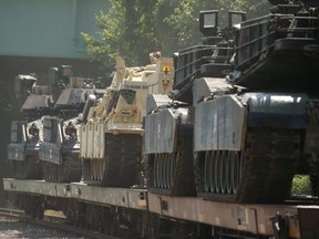 M1 Abrams tanks and other armoured vehicles sit atop flat cars in a rail yard after U.S. President Donald Trump said tanks and other military hardware would be part of Fourth of July displays of military prowess in Washington, D.C., on Tuesday, July 2, 2019.