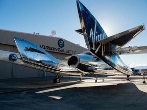 In this file photo taken on February 22, 2019 courtesy of Virgin Galactic, SpaceShipTwo mates to the mothership, WhiteKnightTwo, at Mojave Space Port on February 19, 2019, in Mojave, California. (AFP PHOTO / Virgin Galactic)