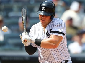 Luke Voit of the New York Yankees is hit in the mouth with a pitch in the fourth inning against the Colorado Rockies at Yankee Stadium on July 20, 2019 in New York City.