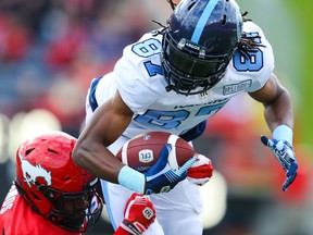 Argos’ Derel Walker is tackled by Stamps’ DaShaun Amos during Toronto’s Week 6 loss in Calgary.