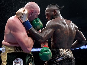 Deontay Wilder and Tyson Fury punch each other in the ninth round fighting to a draw during the WBC Heavyweight Champioinship at Staples Center on Dec. 1, 2018, in Los Angeles.