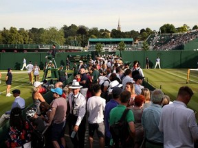 General view as fans watch matches at the All England Lawn Tennis and Croquet Club during Wimbledon, in London, on Thursday, July 4, 2019.