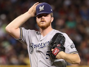 Starting pitcher Brandon Woodruff of the Milwaukee Brewers reacts after giving up a two-run home run to Alex Avila (not pictured) of the Arizona Diamondbacks during the second inning of the MLB game at Chase Field on July 21, 2019 in Phoenix, Ariz.