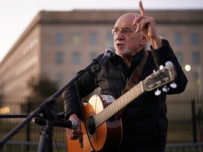 Peter Yarrow, founding member of the legendary folk group Peter, Paul and Mary, speaks about the 1967 March on the Pentagon during a vigil marking the 50th anniversary of the protest outside the Pentagon Oct. 20, 2017 in Arlington, Va.