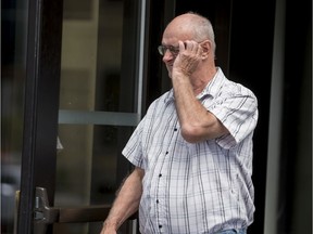 Former Scout leader Donald Sullivan of Ottawa tries to cover his face as he leaves the Ottawa Courthouse on Aug. 13, 2019.