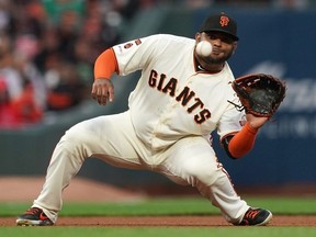 Pablo Sandoval of the San Francisco Giants goes down to catch a line drive off the bat of Brian Dozier of the Washington Nationals in the top of the fourth inning at Oracle Park on August 5, 2019 in San Francisco, California.