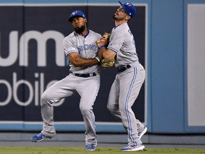 Teoscar Hernandez (left) and Randal Grichuk of the Toronto Blue Jays collide after missing a catch on a ball hit by Chris Taylor of the Los Angeles Dodgers during the fourth inning at Dodger Stadium on August 21, 2019 in Los Angeles, California. (Photo by Harry How/Getty Images)