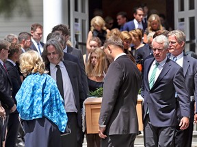 Courtney Kennedy Hill (in blue) and Paul Michael Hill, carrying the casket along with other Kennedy family members, are seen after the funeral mass for their daughter Saoirse Kennedy Hill, granddaughter of Robert F. Kennedy, in Centerville, Massachusetts, U.S., August 5, 2019.  (David L. Ryan/The Boston Globe/Pool via REUTERS)