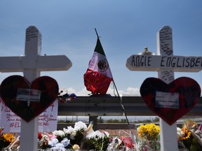 A Mexican flag flutters in the wind at a growing memorial site two days after a mass shooting at a Walmart store in El Paso, Texas, August 5, 2019.  REUTERS/Callaghan O'Hare