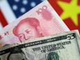 U.S. Dollar and China Yuan notes are seen in this picture illustration June 2, 2017. REUTERS/Thomas White/Illustration/File Photo