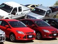 A row of Ford Focus (bottom) are displayed next to Ford F-Series pickups at Koons Ford in Silver Spring, Maryland April 3, 2012.   REUTERS/Gary Cameron