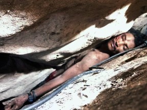 In this photo provided by Battambang province Authority Police, Sum Bora, a 28-year-old man who got stuck in the rock's hollow at Battambang province in northwestern of Phnom Penh, Cambodia, Wednesday, Aug. 7, 2019. Sum Bora, who became wedged between rocks while collecting bat droppings for sale, was rescued Wednesday after being trapped for almost four days.