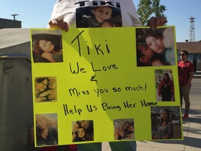 A sign held by Tiki Brook-Lyn Laverdiere's mother Carol at the walk for Ashley Morin on Friday, July 12, 2019.