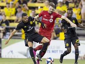 Columbus Crew SC midfielder Artur (8) and Toronto FC forward Patrick Mullins (13) battle for the ball in the second half at MAPFRE Stadium. (Greg Bartram-USA TODAY Sports)