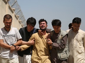 An Afghan man mourns during the funeral of his brother after a wedding suicide bomb blast in Kabul, Afghanistan August 18, 2019. (REUTERS/Omar Sobhani)