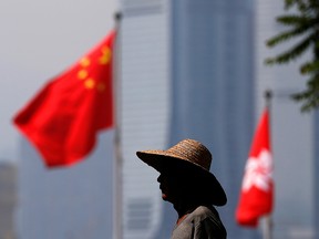 A gardener waters plants at a park near the City Hall in Hong Kong, China, August 22 , 2019. (REUTERS/Kai Pfaffenbach )