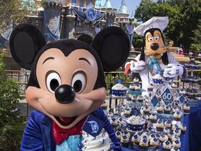 In this handout photo provided by Disney Parks, on the eve of the 60th anniversary of the Disneyland Resort, Mickey Mouse and Goofy help prepare celebratory cupcakes July 16, 2015 at Disneyland park in Anaheim, California.
