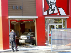 Calgary Fire and Police investgate after a car drove into the KFC on 17ave. and 12 str. S.W. in Calgary on Monday, August 5, 2019. Darren Makowichuk/Postmedia