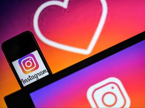 A file photo taken on May 2, 2019 shows logos of social network Instagram are displayed on the screen of a computer and a smartphone in Nantes, western France. (LOIC VENANCE/AFP/Getty Images)