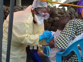 A child receives a vaccine against Ebola from a nurse in Goma on August 7, 2019. - Three cases of the deadly virus was detected in the border city of Goma, the Congolese presidency said on August 1, 2019. (AUGUSTIN WAMENYA/AFP/Getty Images)