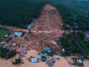 This aerial view shows a landslide in Thalphyugone village in Paung township, Mon state on August 9, 2019. - A landslide caused by heavy monsoon rains killed at least 13 people and injured dozens more in eastern Myanmar, officials said on August 9, as floods forced tens of thousands across the country to flee their homes.
