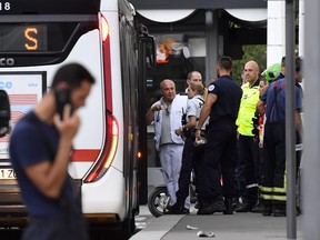 Emergency services are at work near a bus in Villeurbanne on the outskirts of Lyon, south-eastern France on August 31, 2019, after a knife attack which has left one dead and six injured. - Two men, one armed with a knife and the other with a skewer, carried out the attack in Villeurbanne in southeastern France, the official said, without giving further details on the motive for the stabbing. (Photo by PHILIPPE DESMAZES / AFP)