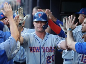 New York Mets first baseman Pete Alonso celebrates his three-run home run with teammates in the first inning against the Atlanta Braves at SunTrust Park.