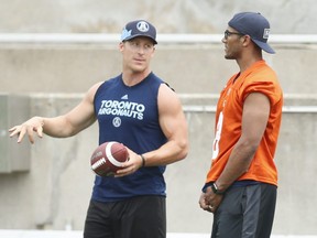 Argos long-snapper Jake Reinhart (left), here chatting with injured teammate James Franklin at practice, is looking to be back in the lineup tomorrow against Edmonton after spending six games on the injured list — a first in his football career.