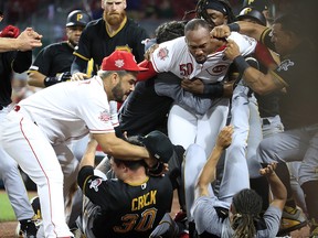 Amir Garrett (middle white shirt without hat) of the Cincinnati Reds engages members of the Pittsburgh Pirates during a bench clearing altercation at Great American Ball Park on July 30, 2019 in Cincinnati. (Andy Lyons/Getty Images)
