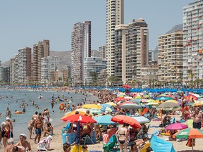 People sunbathe at Levante Beach on July 21, 2019 in Benidorm, Spain.