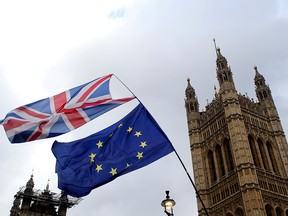 Flags flutter outside the Houses of Parliament, ahead of a Brexit vote, in London March 13, 2019. (REUTERS/Tom Jacobs/File Photo)