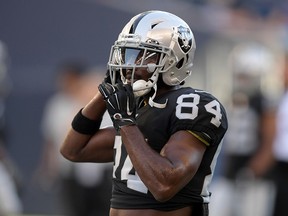 Oakland Raiders wide receiver Antonio Brown (84) adjusts his helmet before a game against the Green Bay Packers at Investors Group Field. (Kirby Lee-USA TODAY Sports)