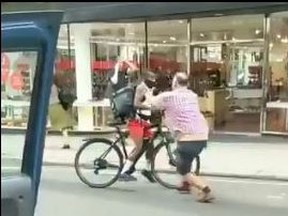 In a video posted on Twitter, a cab driver is seen pushing a cyclist, who was allegedly chasing the car and shouting curse words. Screen shot/Twitter/@yorkshire_G