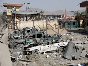 Damaged police vehicles are seen at the site of a blast in Kabul, Afghanistan, Aug.  7, 2019.