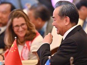 China's Foreign Minister Wang Yi (R) and Canada's Foreign Minister Chrystia Freeland react during the 26th Association of Southeast Asian Nations (ASEAN) Regional Forum (ARF) in Bangkok on Aug. 2, 2019.