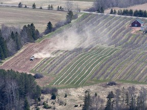 A worker fertilizes a field in Pereaux, N.S., on April 22, 2016.