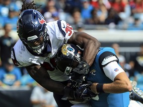 Cody Kessler of the Jacksonville Jaguars is tackled by Jadeveon Clowney of the Houston Texans at TIAA Bank Field on October 21, 2018 in Jacksonville, Florida. (Sam Greenwood/Getty Images)