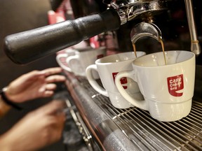 An employee prepares coffee for customers at a Cafe Coffee Day outlet. (REUTERS/Danish Siddiqui/File Photo)