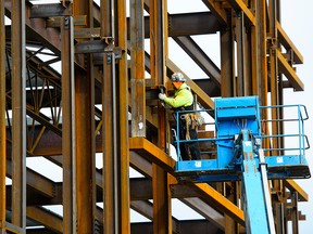 A steel worker builds a structure in Ottawa on Monday, March 5, 2018.